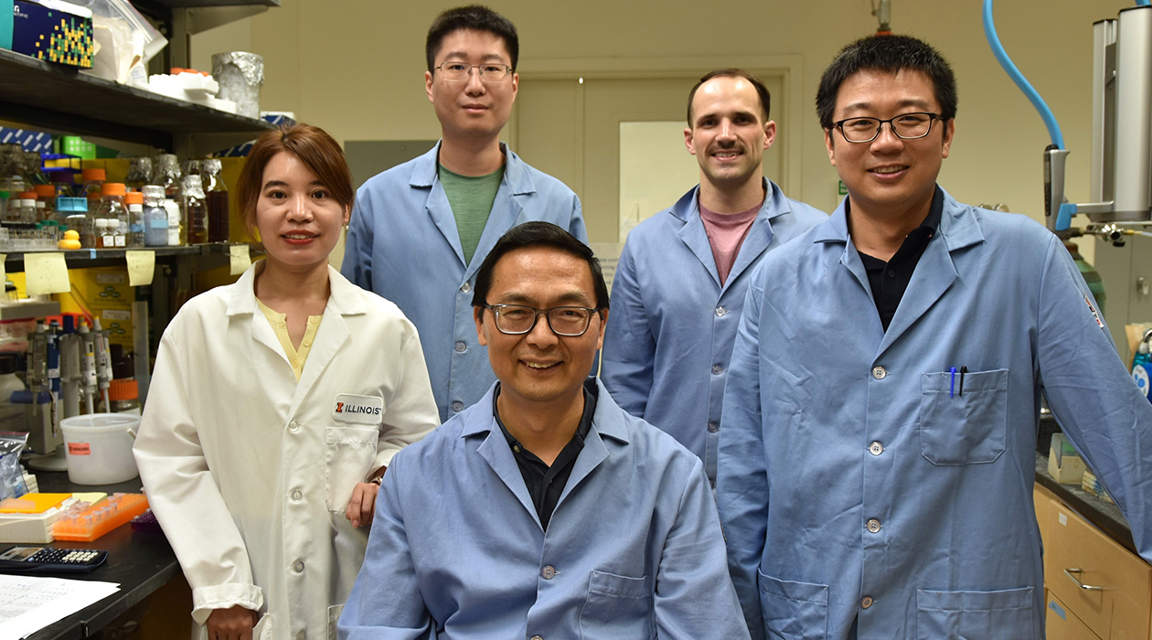from left, Postdoc Yujie Yuan, Postdoc Zhengyi Zhang, CABBI Conversion Theme Leader Huimin Zhao (seated), Ph.D. Candidate Wesley Harrison, and Postdoc Maolin Li.